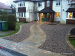 Sweeping sandstone path installed leading to front door, driveway perimeter edged with sandstone setts all hand pointed, Natural sandstone wall constructed with crease tile and 6mm Scottish beach gravel installed to drive