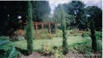 Curved timber Arbour built leading to Timber arch bridge over water feature