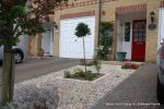 Scottish beach cobbles inset into mortar bed with planting pockets edging with sandstone setts 