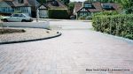 AFTER: Sweeping curved driveway installed with Marshalls Driveline 50 in brindle and Charcoal Kerbs  