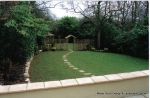 Fresh topsoil and new lawn installed with curved stepping stone path leading to tranquil arbour seating all overgrown shrubs and trees carefully cutback and new feature planting with lighting and irrigation installed