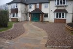 Sweeping sandstone path installed leading to front door, driveway perimeter edged with sandstone setts all hand pointed, Natural sandstone wall constructed with crease tile and 6mm Scottish beach gravel installed to 