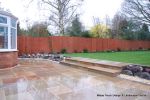 Patio installed with 4 size sawn sandstone paving edged with firestone rocks and alpine planting, steps built with sawn sandstone uprights and sawn sandstone bullnose treads