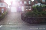 AFTER: Driveway installed with Tegula paving laid at 45 degree to property with in set lighting and feature wall merging into timber wall along front garden and road boundary