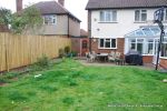 BEFORE: The patio was poorly built and to small and the lawn and beds were drab and tired looking