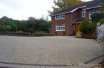 AFTER: New larger driveway constructed using pewter grey paving with contrasting colour band and feature curved double row of kerbs with Topiary hedge to retain level change.