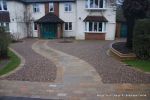 Sweeping sandstone path installed leading to front door, driveway perimeter edged with sandstone setts all hand pointed, Natural sandstone wall constructed with crease tile and 6mm Scottish beach gravel installed to drive