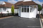 New driveway installed using granite paving with contrasting colour band and inset lights