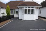 New driveway installed using granite paving with contrasting colour band and inset lights