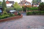 Driveway installed with Tegula paving laid at 45 degree to property with in set lighting and feature wall merging into timber wall along front garden and road boundary