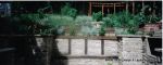 Sunken patio/dining area with natural Cotswald random stone retaining Walls with Integral BBQ and timber beams 