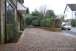 Sweeping sandstone path installed leading to front door, driveway perimeter edged with sandstone setts all hand pointed, Natural sandstone wall constructed with crease tile and 6mm Scottish beach gravel installed to drive