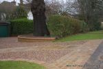 AFTER: Sweeping sandstone path installed leading to front door, driveway perimeter edged with sandstone setts all hand pointed, Natural sandstone wall constructed with crease tile and 6mm Scottish beach gravel installed to drive.