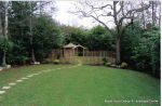 Fresh topsoil and new lawn installed with curved stepping stone path leading to tranquil arbour seating all overgrown shrubs and trees carefully cutback and new feature planting with lighting and irrigation installed