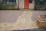 Sweeping sandstone path installed leading to front door, driveway perimeter edged with sandstone setts all hand pointed, Natural sandstone wall constructed with crease tile and 6mm Scottish beach gravel installed to 