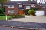 AFTER: New larger driveway constructed using pewter grey paving with contrasting colour band and feature curved double row of kerbs with Topiary hedge to retain level change.