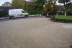 AFTER: New larger driveway constructed using pewter grey paving with contrasting colour band and feature curved double row of kerbs with Topiary hedge to retain level change.