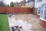 Patio installed with 4 size sawn sandstone paving edged with firestone rocks and alpine planting, steps built with sawn sandstone uprights and sawn sandstone bullnose treads