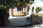 AFTER: Driveway constructed using Tegula paving with sweeping curved path to front door and feature band across drive mouth, new wall, lawn and planting installed.