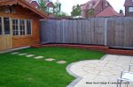 Garden was on a new development new Saxon paving with circle feature installed new lawn, stepping stones and low planter wall summer house with hot tub and lighting installed