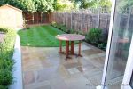 patio was constructed useing fossil sandstone in 4 sizes laid to a random pattern with a curved block planter wall painted in gun ship grey and planted with a topiary hedge.