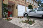 Scottish beach cobbles inset into mortar bed with planting pockets edging with sandstone setts 