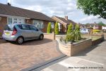 Curved Brick planter wall with crease tile and brick on edge to finish