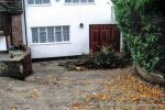 BEFORE: Old concrete driveway broken and crumbling