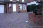 Driveway installed with Tegula paving laid at 45 degree to property with in set lighting and feature wall merging into timber wall along front garden and road boundary