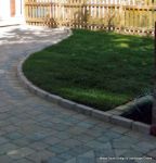 Driveway constructed using Tegula paving with sweeping curved path to front door and feature band across drive mouth, new wall, tier drop lawn and planting installed.