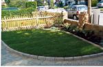 AFTER: Driveway constructed using Tegula paving with sweeping curved path to front door and feature band across drive mouth, new wall, lawn and planting installed.