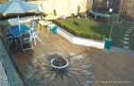 Sandstone sunflower inset in decking 