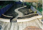 Soft wood decking with terracotta tile octagon feature incorporated into it