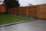 New Granite patio and path installed with contrasting dark colour band, New lawn, fencing and planting installed