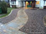 Sweeping sandstone path installed leading to front door, driveway perimeter edged with sandstone setts all hand pointed, Natural sandstone wall constructed with crease tile and 6mm Scottish beach gravel installed to drive