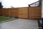 New Granite patio and path installed with contrasting dark colour band, New lawn, fencing and planting installed