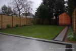 New Granite patio and path installed with contrasting dark colour band, New lawn, fencing and planting installed