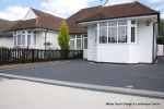 New driveway installed using granite paving with contrasting colour band and inset lights