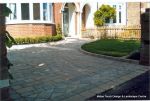 AFTER: Driveway constructed using Tegula paving with sweeping curved path to front door and feature band across drive mouth, new wall, lawn and planting installed.